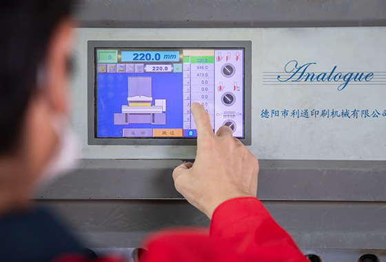 a-worker-putting-fingers-on-the-machine-control-board
