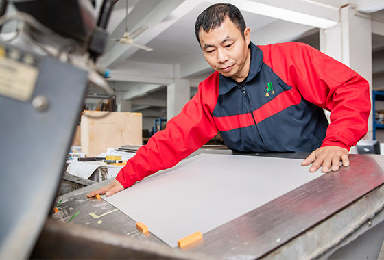 a-worker-using-the-die-cutting-machine