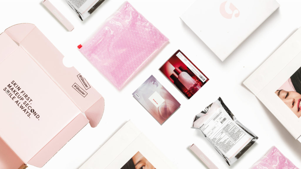 Glossier minimalist pink skincare packaging design