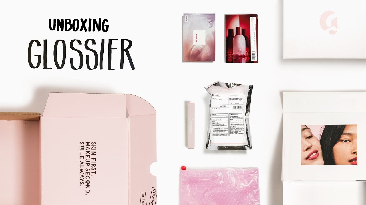 luxury unboxing with glossier branded tissue paper and handwritten note
