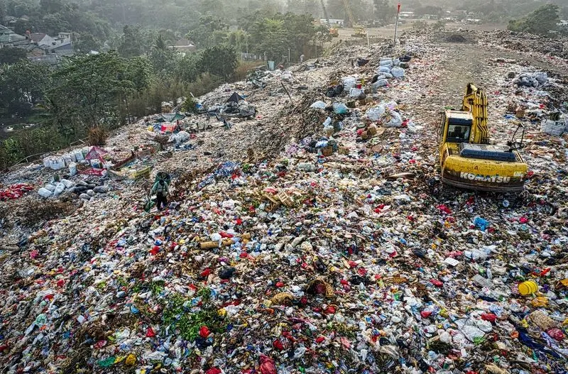 piles of plastic packaging waste in landfill site environmental pollution