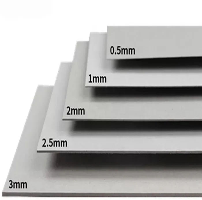 eco friendly greyboard material closeup showing smooth surface, rigidity, and varying thickness
